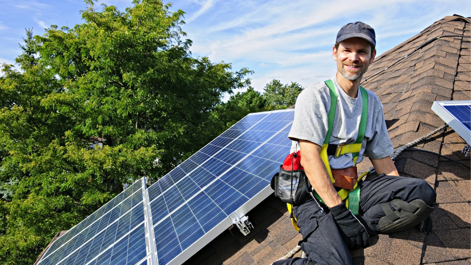 Man on roof with solar panels
